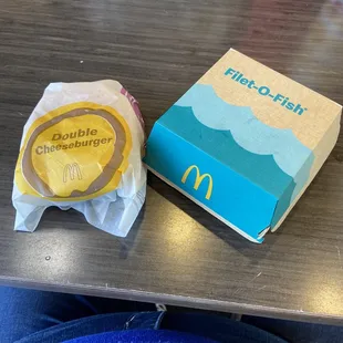 a hamburger and a drink on a table