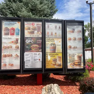 menus displayed on a sign in front of a brick building