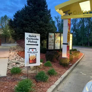 a sign in front of a fast food restaurant