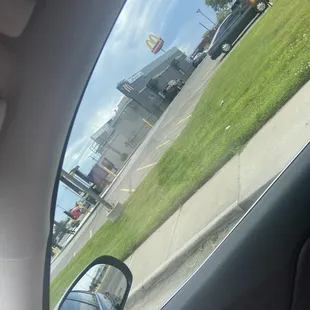 a view of a parking lot from inside a car