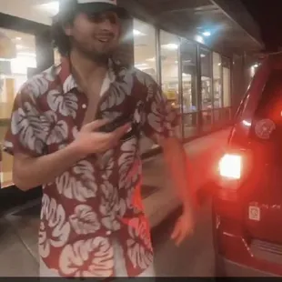 a man standing in front of a car
