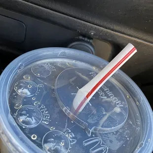 a plastic cup with a straw sticking out of it