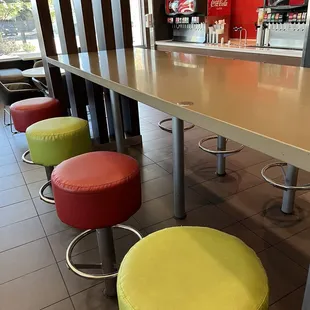 a row of brightly colored stools