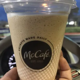 a hand holding a cup of coffee