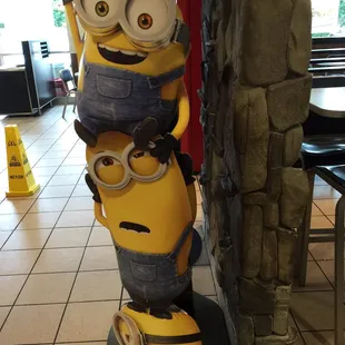 a statue of a minion holding a banana