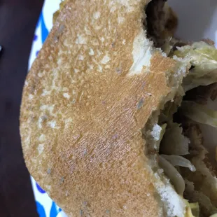 a half eaten sandwich on a plate