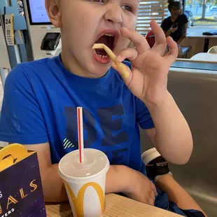 a young boy eating a donut