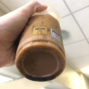 a hand holding a cup of coffee