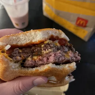 a hand holding a hamburger