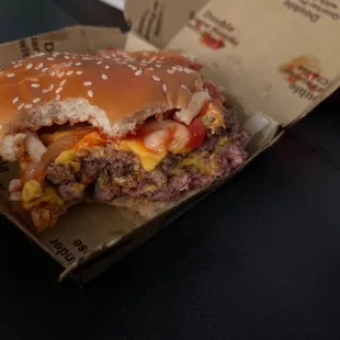 a cheeseburger with a bite taken out of it