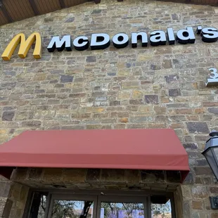 Beautiful brick and steel outside with new red awning