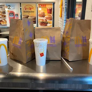 a row of paper bags and cups