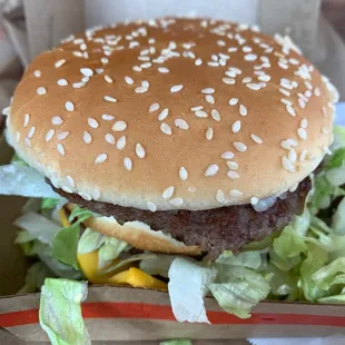 a hamburger with lettuce and cheese
