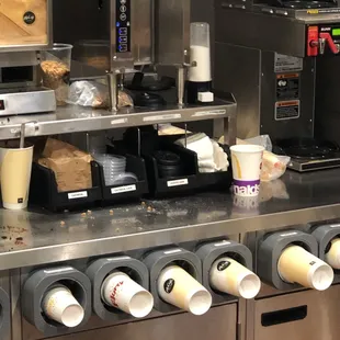 a coffee machine and coffee cups on a counter