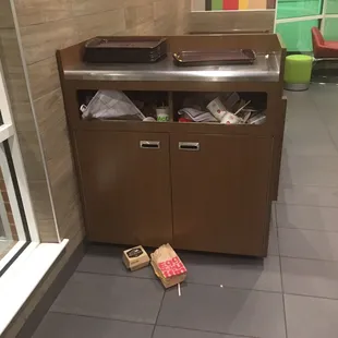 a trash can in the middle of the floor