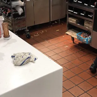 a dirty kitchen with a mess on the floor