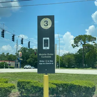 a street sign with a phone on it