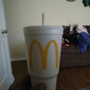 a person holding a cup with a straw