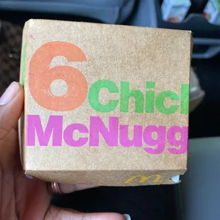 a person holding a box of food