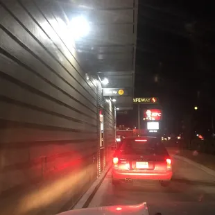 a car driving down a street at night