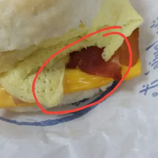 You can only see the top of the hair. It's melted into the cheese and comes out the top of the cheese and over the bacon.
