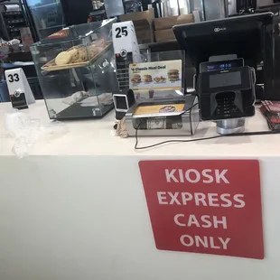 A mess on the counter where you pay cookies display are broke