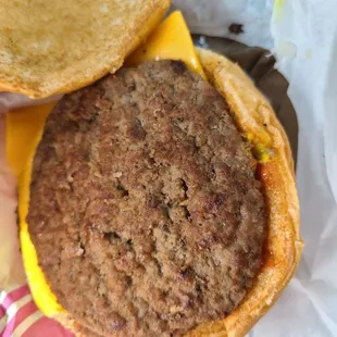 a hand holding a hamburger