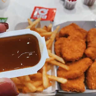 a tray of chicken nuggies and french fries
