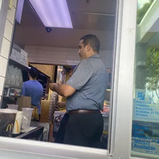 Racist Manger on his phone at work. Wants me to serve myself. Instead of just handing me a water. Profiling instead