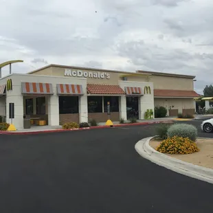 a white car parked in front of a mcdonald's