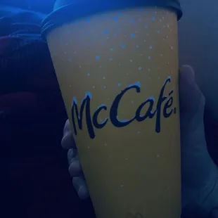 a person holding a cup of coffee