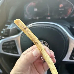 a hand holding a piece of bread