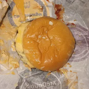 a half eaten cheeseburger and fries