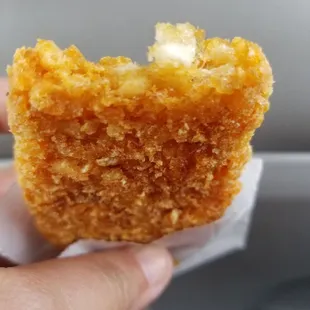 a person holding a piece of food