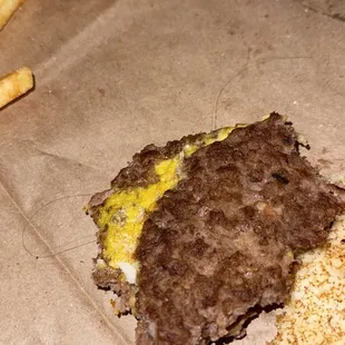 a half eaten hamburger and fries