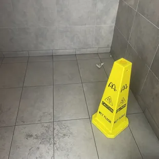 Walk into Entrance door with stickiness and a cone that's been there for a while and not being cleaned .