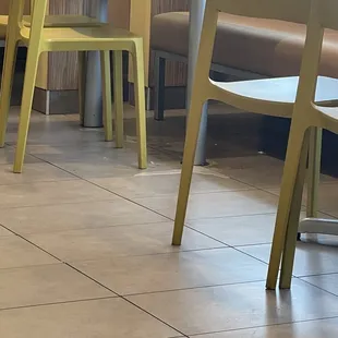 Spilled drink underneath the table that hasn't been clean for a while and only left with just a caution cone. Not being cleaned right away