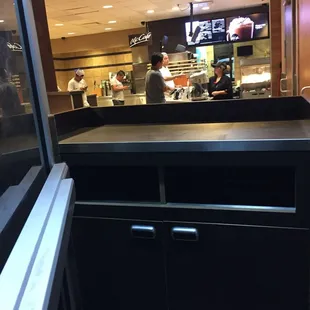 a view of the kitchen from inside the restaurant