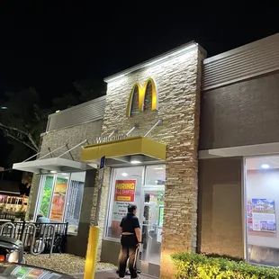 a man walking out of a mcdonald's