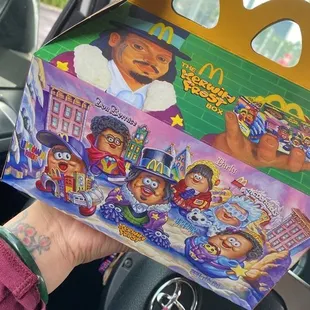 a hand holding a box of food