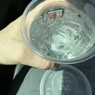 a person holding a cup of water