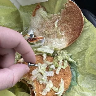 a person cutting into a sandwich