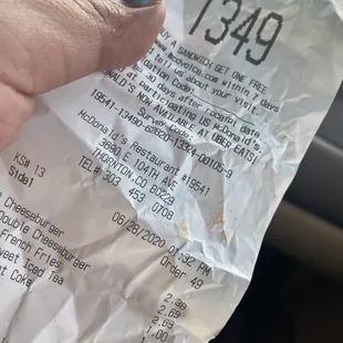 a person holding a receipt in their hand