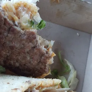 a half eaten sandwich in a box