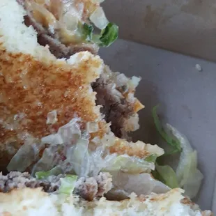 a half eaten sandwich in a box