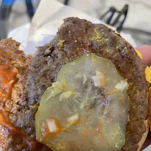 a hamburger with a pickle on it