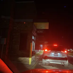 a car driving down a street at night