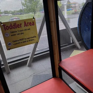 a toddler area with a sign on the door