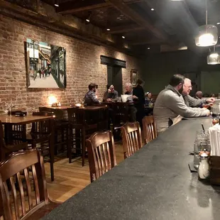 people sitting at tables in a restaurant