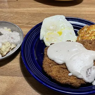 Country fried steak with eggs, hash browns, and 1/2 biscuit and gravy.